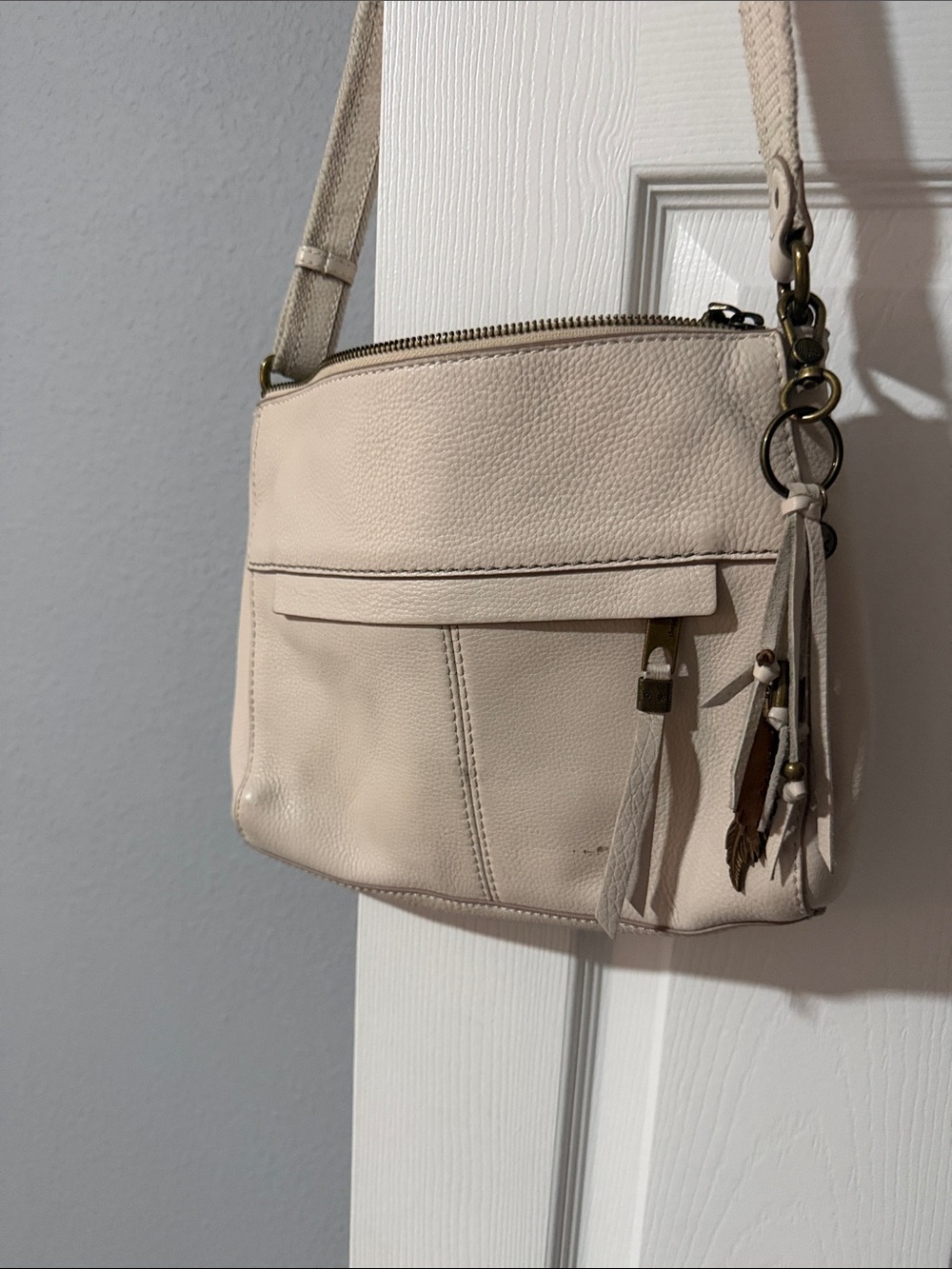 The Sak Cream Leather Crossbody with Tassel Charm